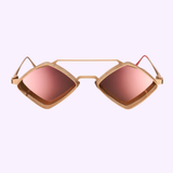 Handcrafted in Italy, the Vysen Jaxs J-6 Unisex Sunglasses by Vysen Sunglasses feature a striking gold frame with geometric, diamond-shaped lenses tinted pink and distinctive mesh detailing around the edges. These standout frames are showcased against a light purple background.