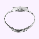 Side view of a Seiko SRPE33 Prospex Men's watch by Seiko Watches, featuring a silver stainless steel strap and clasp, displayed against a light purple background.