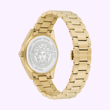 The Versace Watches VE6A00623 V-Code watch, shown from the back, features a gold metal band and an engraved Medusa head on the case back along with the inscriptions “Stainless Steel, Sapphire Crystal, Swiss Made.” Versace branding is prominently displayed on the clasp of this sophisticated men's watch.