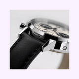 A close-up of the Hamilton Watches American Classic Intra-Matic Auto Chrono 40 mm (H38416711) displays its panda dial, black leather strap, and polished silver case in sharp detail against a softly blurred background.