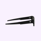 Side view of 100% authentic Tag Heuer Optical sunglasses (TH40061I 5401A) with dark lenses and logo on the temple, set against a light purple background. Available from a Miami Authorized Dealer.