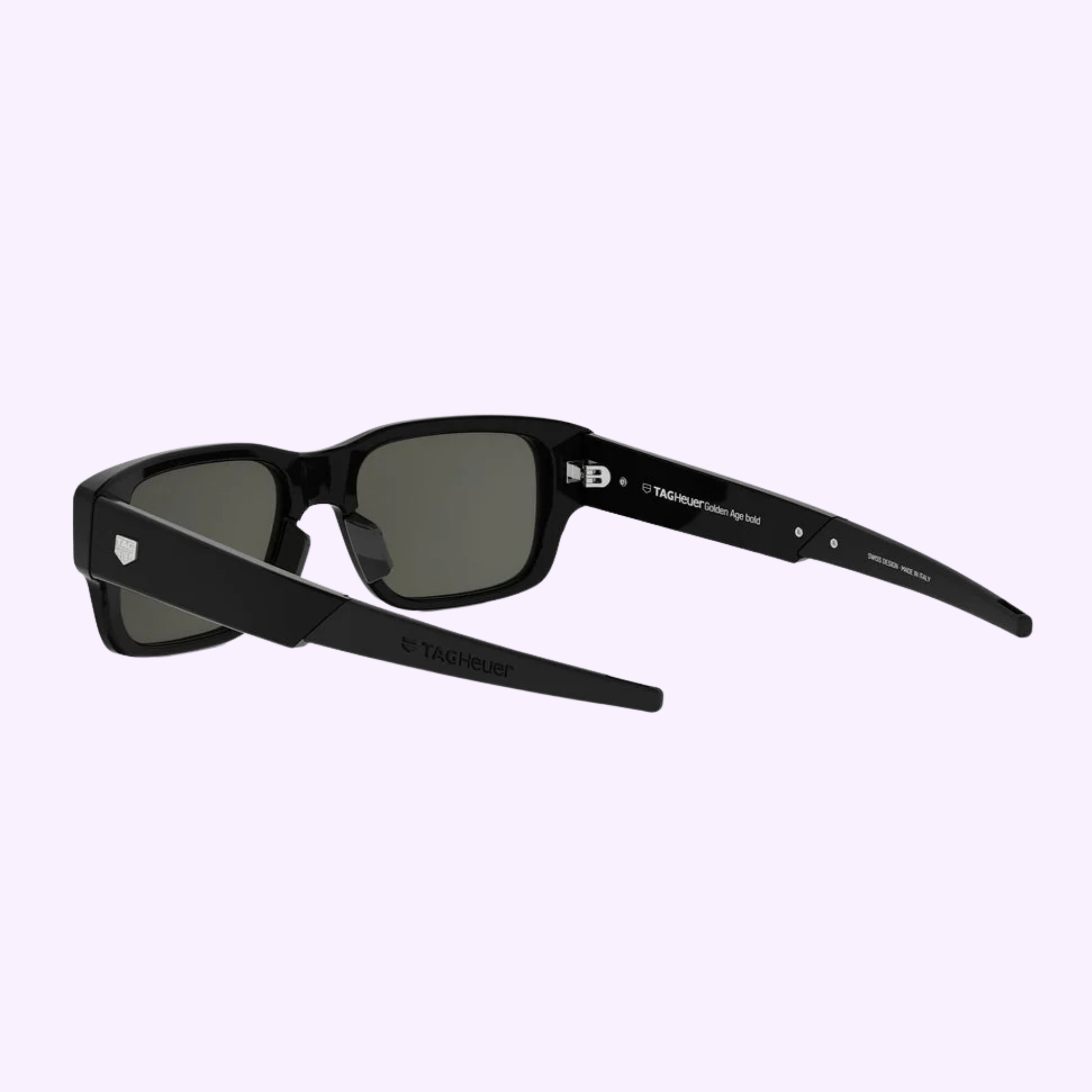 100% authentic Tag Heuer Optical TH40061I 5401A sunglasses with rectangular frames, dark lenses, and branded thick arms are shown on a light purple background. Buy confidently from a Miami Authorized Dealer.