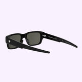 100% authentic Tag Heuer Optical TH40061I 5401A sunglasses with rectangular frames, dark lenses, and branded thick arms are shown on a light purple background. Buy confidently from a Miami Authorized Dealer.