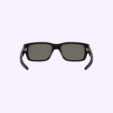 Tag Heuer Optical TH40061I 5401A: rectangular black sunglasses with dark lenses, displayed on a light purple background. 100% authentic, available from an authorized Miami dealer.