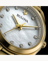 Close-up of the Bulova Watches 97P172, a gold stainless steel ladies’ watch with a white mother-of-pearl dial, diamond hour markers, and a polished gold case and strap.