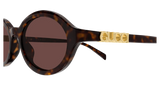 Close-up of Gucci Sunglasses GG2153S 002 51 featuring round tortoiseshell frames, dark lenses, and gold GUCCI lettering on the temple, highlighting modern luxury eyewear style.