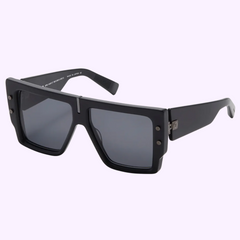 Balmain LIMITED EDITION BPS-144D-57 B-Grand Sunglasses feature an oversized square black frame, dark tinted lenses, thick wide temples with metallic accents near the hinges—making these standout Balmain Sunglasses a bold statement piece.