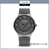 The image shows the Bering Watches 14441-377 Solar Stainless Steel Mesh Strap Men's Watch, featuring a grey mesh band, black dial with white markers, orange seconds hand, date display, plus the Bering logo and Lexor Miami banner at the top.