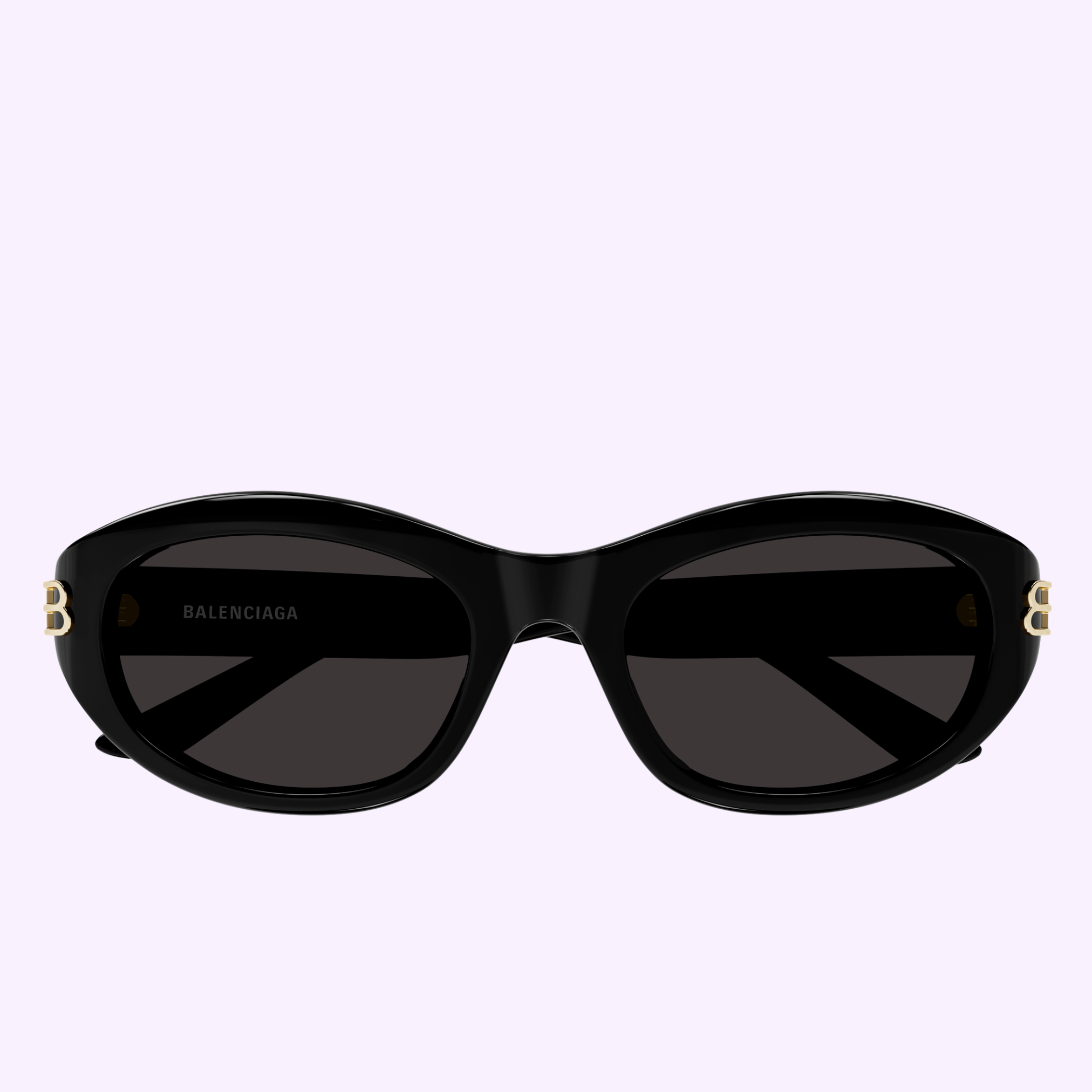 Front view of Balenciaga Sunglass BB0434SK-001 55 with black oval lenses and gold B logos on the temples, displayed on a pale purple background. Available from an Authorized Dealer in Miami.