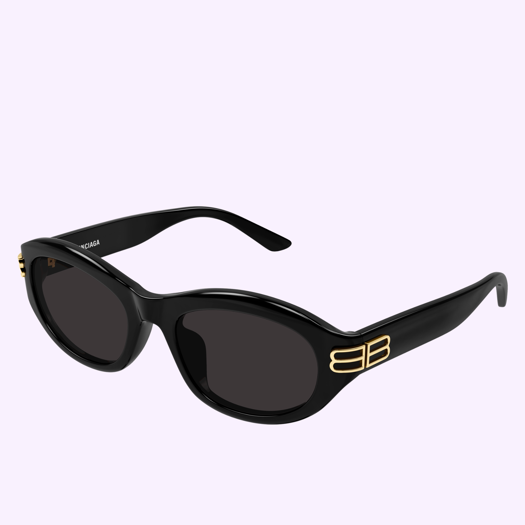 Balenciaga Sunglass BB0434SK-001 55 in black oval frame with dark lenses and gold double-B logo on the arms, shown on a light purple background. Buy confidently from an Authorized Dealer in Miami.