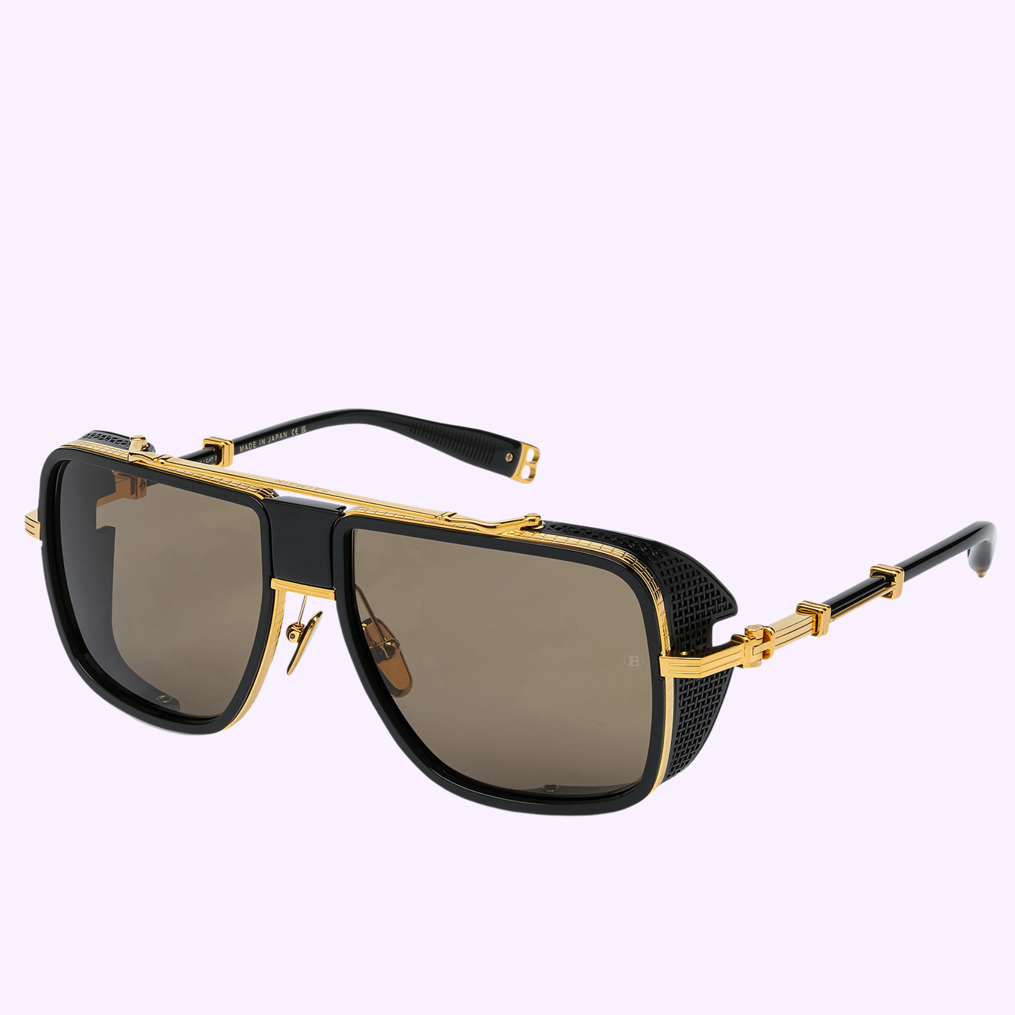 Balmain Sunglasses O.R. BPS-104H-59 by Balmain Sunglasses feature square brown lenses, black rims, gold frame and arm details, and textured side panels—luxury eyewear on a light purple background.