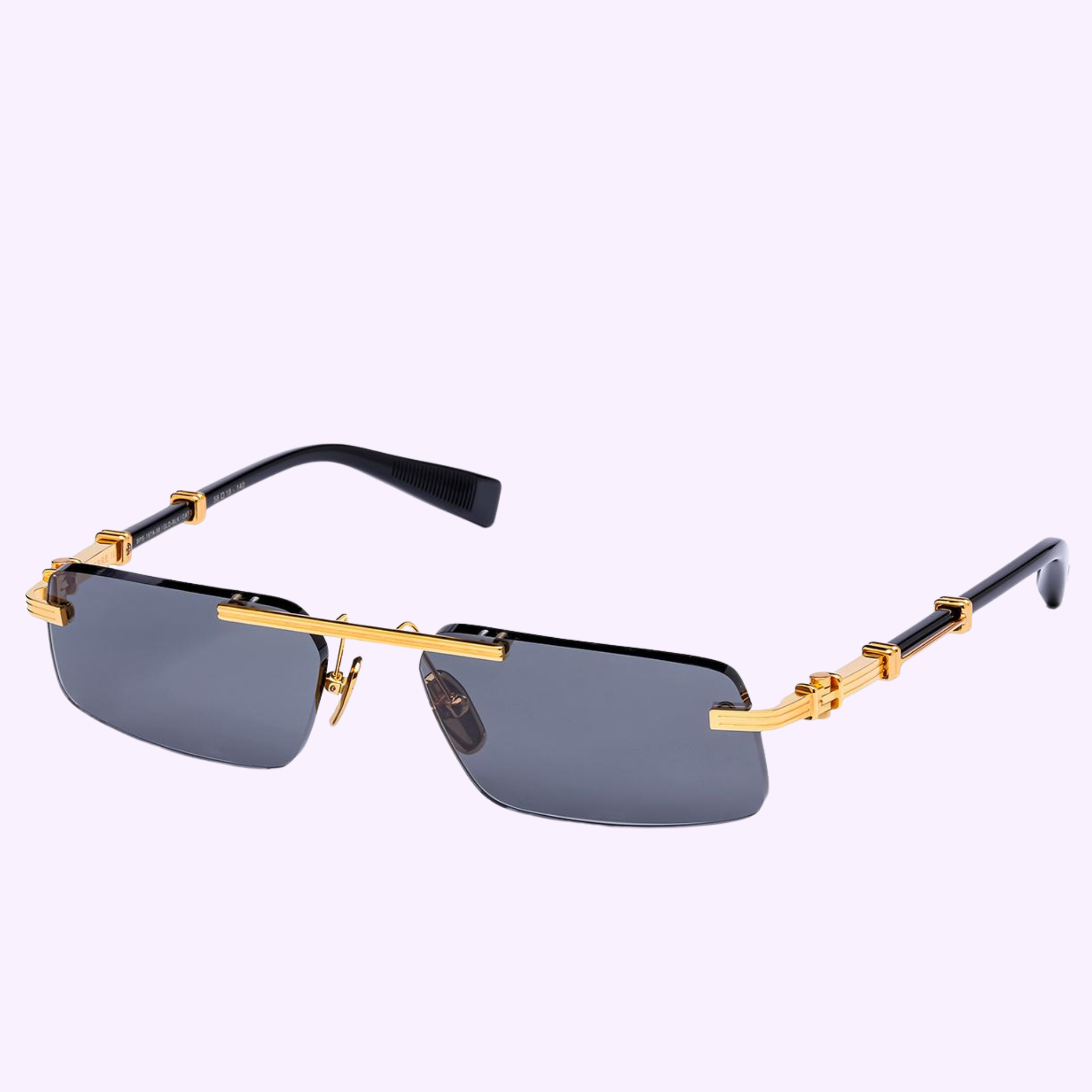 The Balmain Sunglasses PIERRE - II BPS-187A-58 feature a rectangular shape, dark lenses, black arms, and gold metal accents with a signature gold top bar and decorative temples, shown on a pale purple background.