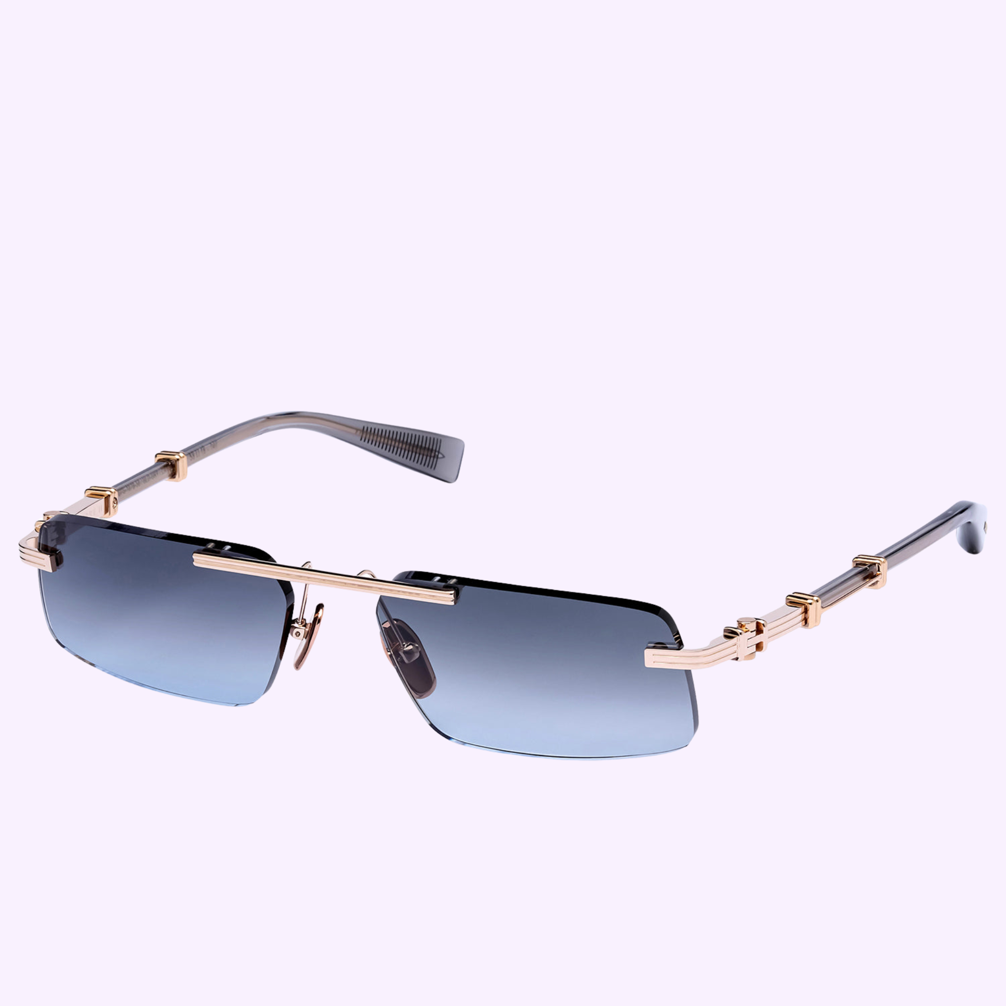 Balmain Sunglasses PIERRE - II BPS-187B-58 feature a rectangular shape, gradient blue lenses, gold accents, and unique geometric arm design. Displayed on a light purple background. Handmade in Japan for luxurious quality.
