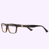 The Bottega Veneta BV1098O 002 54 Unisex Optical Frame by Bottega Veneta Sunglasses showcases luxurious, handcrafted tortoiseshell rectangular eyeglasses with thick frames and the iconic logo on the arms. These unisex optical frames are displayed against a light purple background.