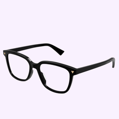 The Bottega Veneta BV1229OA-001 52 Optical Frame WOMAN features black rectangular eyeglasses with thick frames, distinctive gold triangle accents on the front corners, and clear lenses, presented against a light purple background. These handcrafted Italian glasses from Bottega Veneta Sunglasses embody timeless style and premium quality, making them an elegant choice in women’s eyewear.