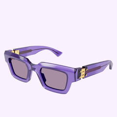 The Bottega Veneta BV1230S-003 49 Sunglass UNISEX RECYCLED features purple, rectangular frames with thick temples and gold metal accents at the hinges, complemented by dark tinted lenses. Displayed on a plain light background, this handcrafted eyewear from Bottega Veneta Sunglasses exudes sophistication and modern luxury.