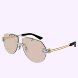 The Bottega Veneta Sunglasses BV1342S-002 59 UNISEX METAL, featuring aviator-inspired rimless frames with light brown lenses, gold double arms, silver hinge accents, and black ear tips, are beautifully showcased on a light purple background—exemplifying the brand’s dedication to luxury eyewear craftsmanship.