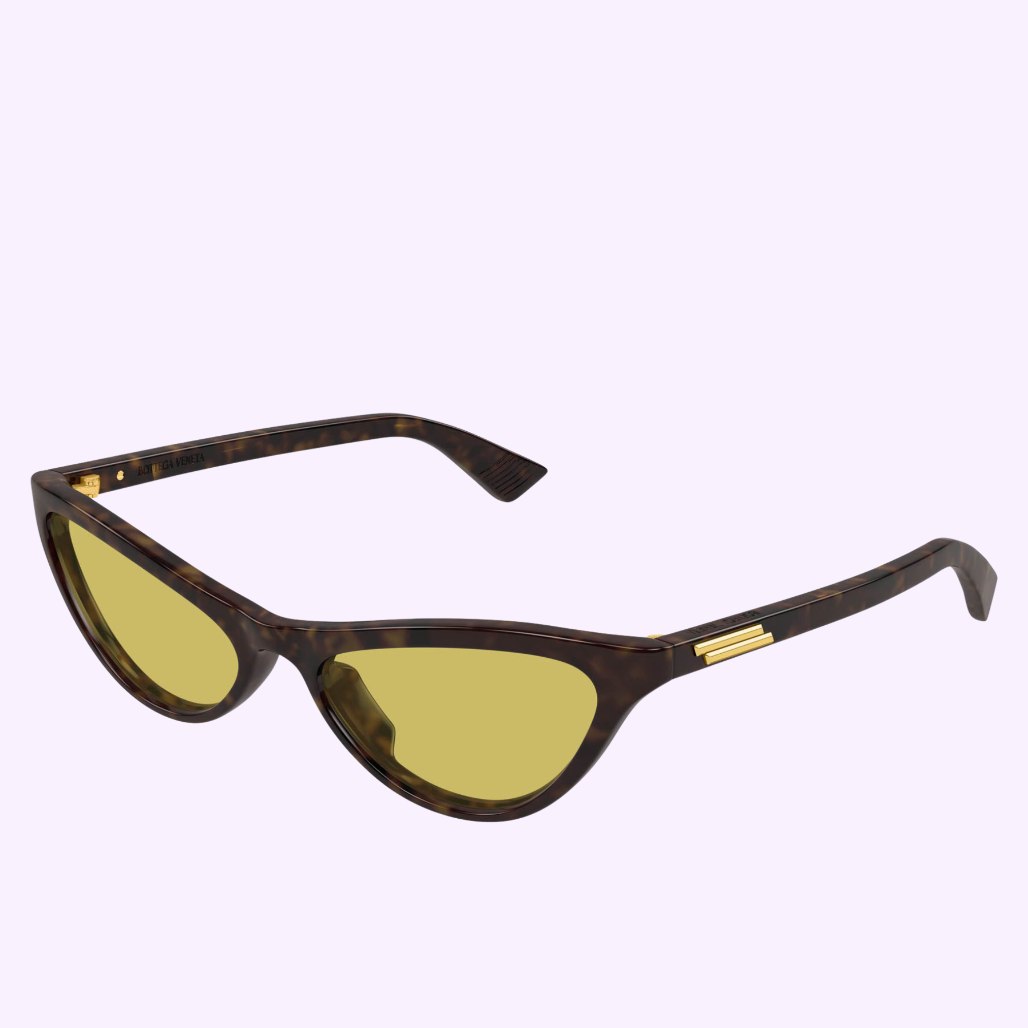 The Bottega Veneta Sunglasses BV1414S-002 56 feature a cat-eye tortoiseshell frame, yellow-tinted lenses, and gold-accented arms—handcrafted luxury eyewear displayed on a light purple background.