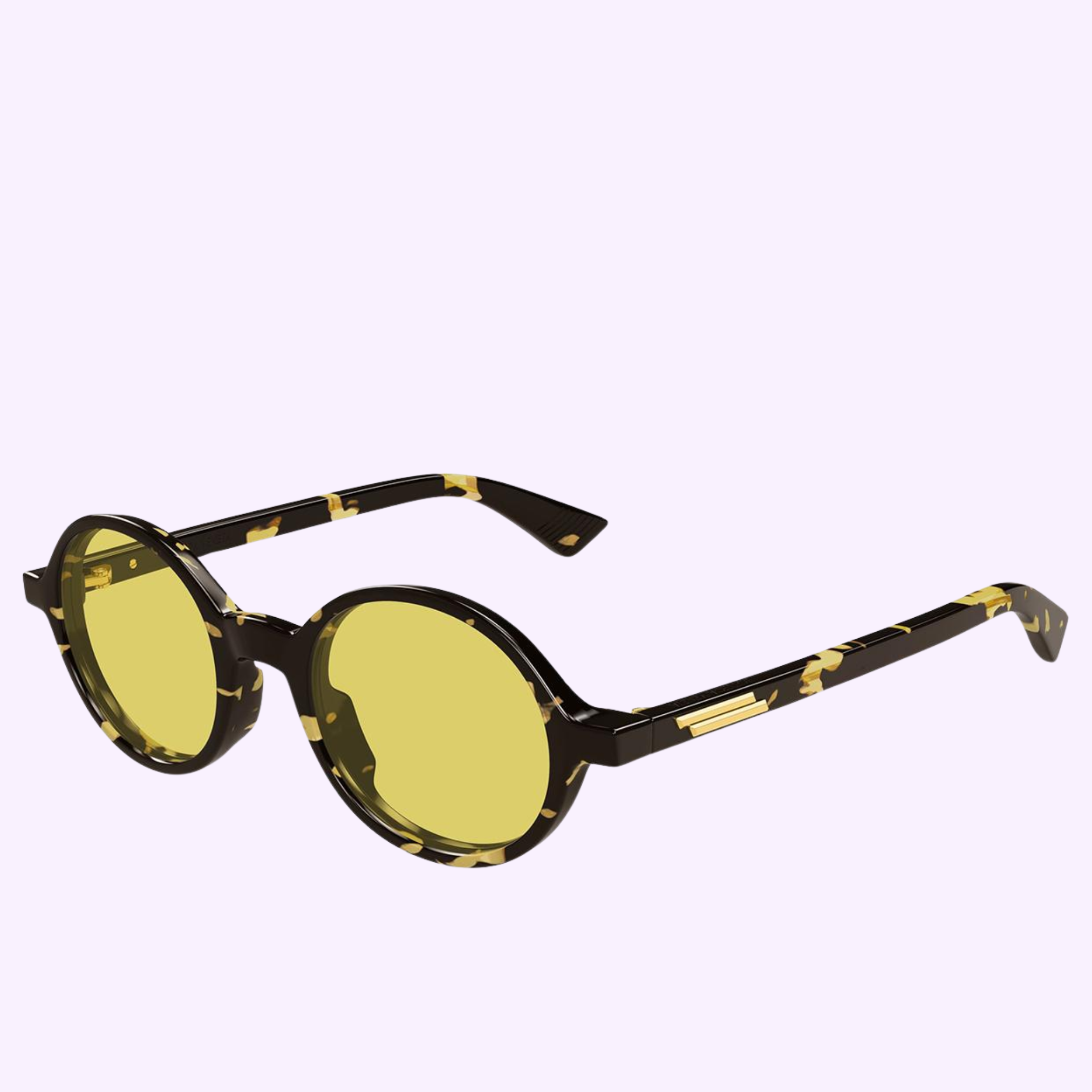 Bottega Veneta Sunglasses BV1430S-002 48 features round, yellow-tinted lenses and a black frame with yellow and gold marbled patterns, shown on a light lavender background.