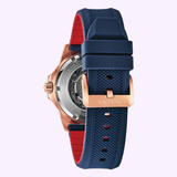 A close-up of the Bulova Watches 98A227 Marine Star Automatic men's watch, featuring a blue and red textured silicone strap with a rose gold buckle, silver case, and visible mechanical movement.