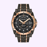 The Bulova 98D149 Precisionist men's watch by Bulova Watches features a black/rose gold metal band and case, black patterned dial, luminous hands, date display, 300m water resistance—all set on a light pink background.