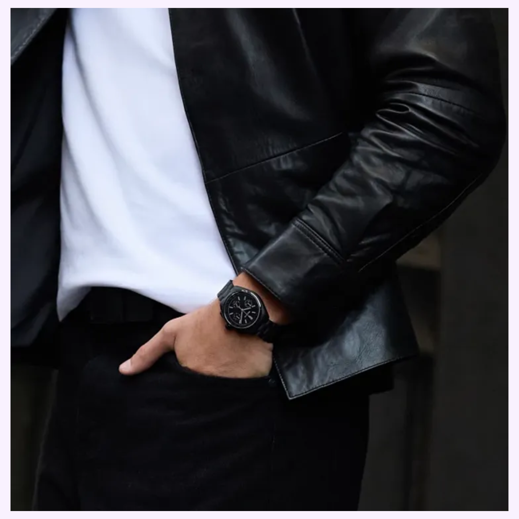 Dressed in a black leather jacket, white shirt, and black pants, a person poses with one hand in their pocket, showcasing the Bulova Watches Lunar Pilot Black Hole 98A335 Limited Edition against a dark, blurred background.