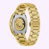 Gold-tone Bulova Watch Maquina 97A207 men’s watch with an open-heart mechanical movement visible through a glass case back and a matching automatic skeleton link bracelet.