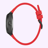 Side view of the Bulova Watches Maquina 98A341, a sleek black watch with a vibrant red silicone strap and buckle, set against a light purple background.