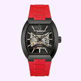 The Bulova Watches Maquina 98A341 showcases a striking black case, an exposed automatic movement, a black dial with silver hands, and is complemented by a bold red band.