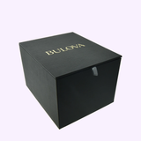A black rectangular box with BULOVA in gold letters on the lid, set against a light background—an elegant presentation for the Bulova Watch Series X Automatic 98A343 by Bulova Watches.