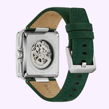 A close-up of the Bulova Watches Series X Automatic 98A343 men's watch showcases its green leather strap, stainless steel case, skeletonized automatic movement, and see-through case back.