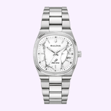 The Bulova Watch Super Seville Magnesite 96A344 by Bulova Watches features a silver case, magnesite dial with a marble-patterned white finish, silver markers and hands, and a stainless steel link band, shown on a light purple background.