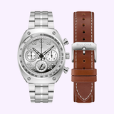 A Bulova Watches Shelby Daytona Coupe 96K118 Limited Edition chronograph watch in silver is displayed next to a brown leather strap with white stitching and a Bulova Watches-branded clasp.