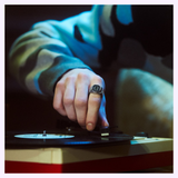 Wearing a G-Shock Watches CASIO RING WATCH CRW001-1, a person adjusts the needle on a vinyl record player, getting ready to play a record.