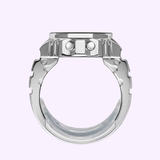 A silver ring reminiscent of a mechanical gear, with angular edges and bolt-inspired details—echoing the intricate craftsmanship of the CASIO RING WATCH CRW001-1 by G-Shock Watches—displayed against a light purple background.