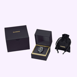 A G-Shock Watches CASIO RING WATCH CRW001-1 digital watch is presented in a black gift box, accompanied by a matching black G-Shock box and a small black drawstring pouch, all arranged against a light background.
