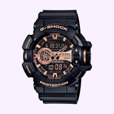The G-Shock Watches CASIO G-Shock GA400GB-1A4 features a rugged black and gold design with analog-digital displays and multiple bezel buttons for durability and style.
