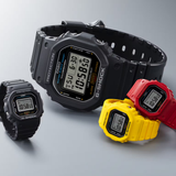 Four G-Shock Watches in black, yellow, and red—including the CASIO G-Shock Watch nano SERIE 5600—are displayed on a gray surface. The collection features bold, rugged designs and includes a miniature G-SHOCK model, demonstrating the innovative styles from G-Shock Watches that display both time and date.