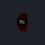 A CASIO G-Shock Watch nano SERIE 5600 by G-Shock Watches, in striking red, displays the time 10:56:50 PM on its screen against a dark background.