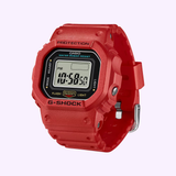 Introducing the CASIO G-Shock Watch nano SERIE 5600 by G-Shock Watches—a striking red digital timepiece with a square face, black bezel, and silver buckle. Displaying the time 10:58:50, this unique model mirrors a classic miniature G-SHOCK design and features mode, adjust, and light buttons for versatile functionality.