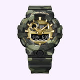 A standout model from the CASIO G-Shock Watch Bold Camo Series, the GA700CMG-3A by G-Shock Watches features a vibrant green camouflage design, gold-accented face, both digital and analog displays, and multiple function buttons for convenient time and date viewing.