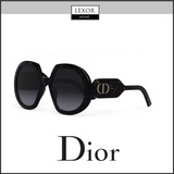 The image shows Christian Dior DiorBobby R1U 20A1 56 unisex oversized black sunglasses with dark lenses and tortoiseshell frames, gold CD logo on the temple, and Lexor Miami and Dior Sunglasses branding.