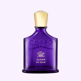 A purple glass bottle of CREED QUEEN OF SILK 2.5 EDP Woman Perfume by Creed Perfumes, featuring gold accents, is displayed against a light lavender background—an elegant fragrance choice for women who love luxury scents.