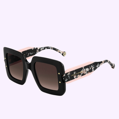 A pair of Carolina Herrera Sunglasses HER 0322/S 3H2 BLACKPINK with oversized square black frames, gradient lenses, and wide temples in a pink floral marble pattern, displayed on a light purple background.