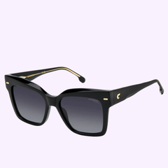 The Carrera Sunglasses CARRERA 3037/S by Carrera Sunglasses feature bold black square frames, sleek dark gradient lenses, and gold accents on the temples, all set against a light purple background—capturing Miami’s vibrant flair with unmistakable style.