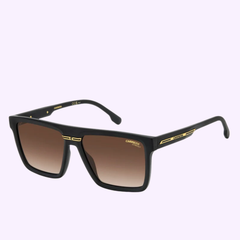 The Carrera Sunglasses VICTORY C 03/S feature a sleek black rectangular design with brown gradient lenses and gold accents on the arms and frame, capturing a Miami-inspired aesthetic. They are set against a light purple background.