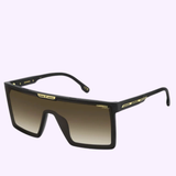 Carrera Sunglasses VICTORY C 07/S 7C5 are black oversized shield sunglasses with a flat top, highlighted by gold accents and a gradient brown lens. Set against a light purple background, these premium designer Carrera Sunglasses showcase the Carrera brand name boldly on both the frame and temples.