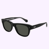 The Cartier CT0277S-001 Men Acetate Sunglass by Cartier Sunglasses features a black acetate frame with dark lenses and thick design, shown on a light purple background.