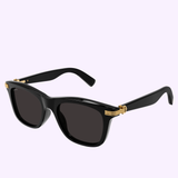 Cartier CT0396S-001 53 Men Sunglasses by Cartier Sunglasses, featuring a black rectangular frame with dark lenses and gold-accented hinges, are displayed against a light purple background.