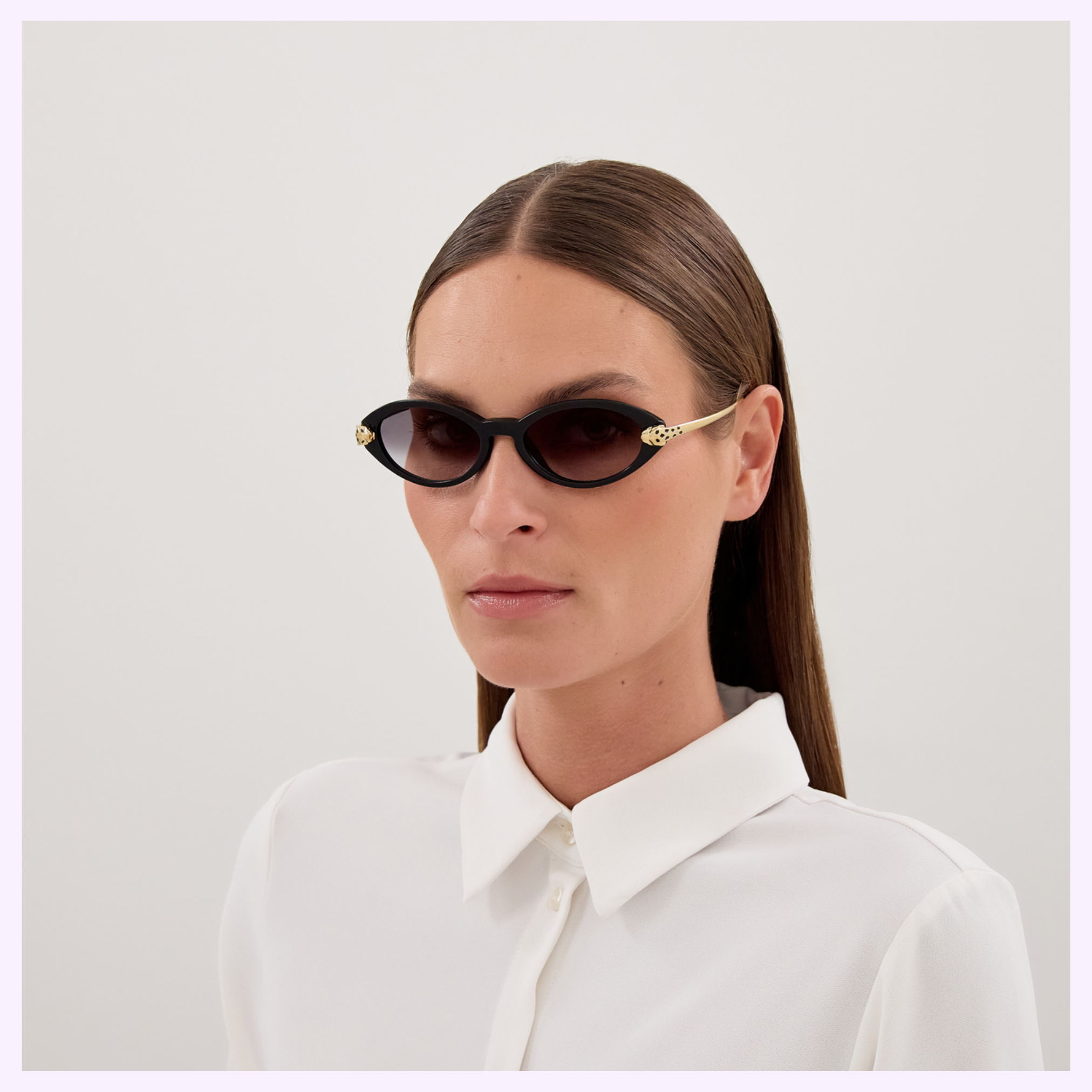 A person with straight brown hair, wearing Cartier Sunglasses CT0634S-001 52 and a white collared shirt, stands against a plain light background, showcasing luxury eyewear from Cartier.